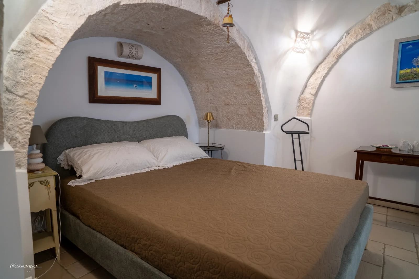 Vista d'insieme del letto matrimoniale sotto la volta in pietra