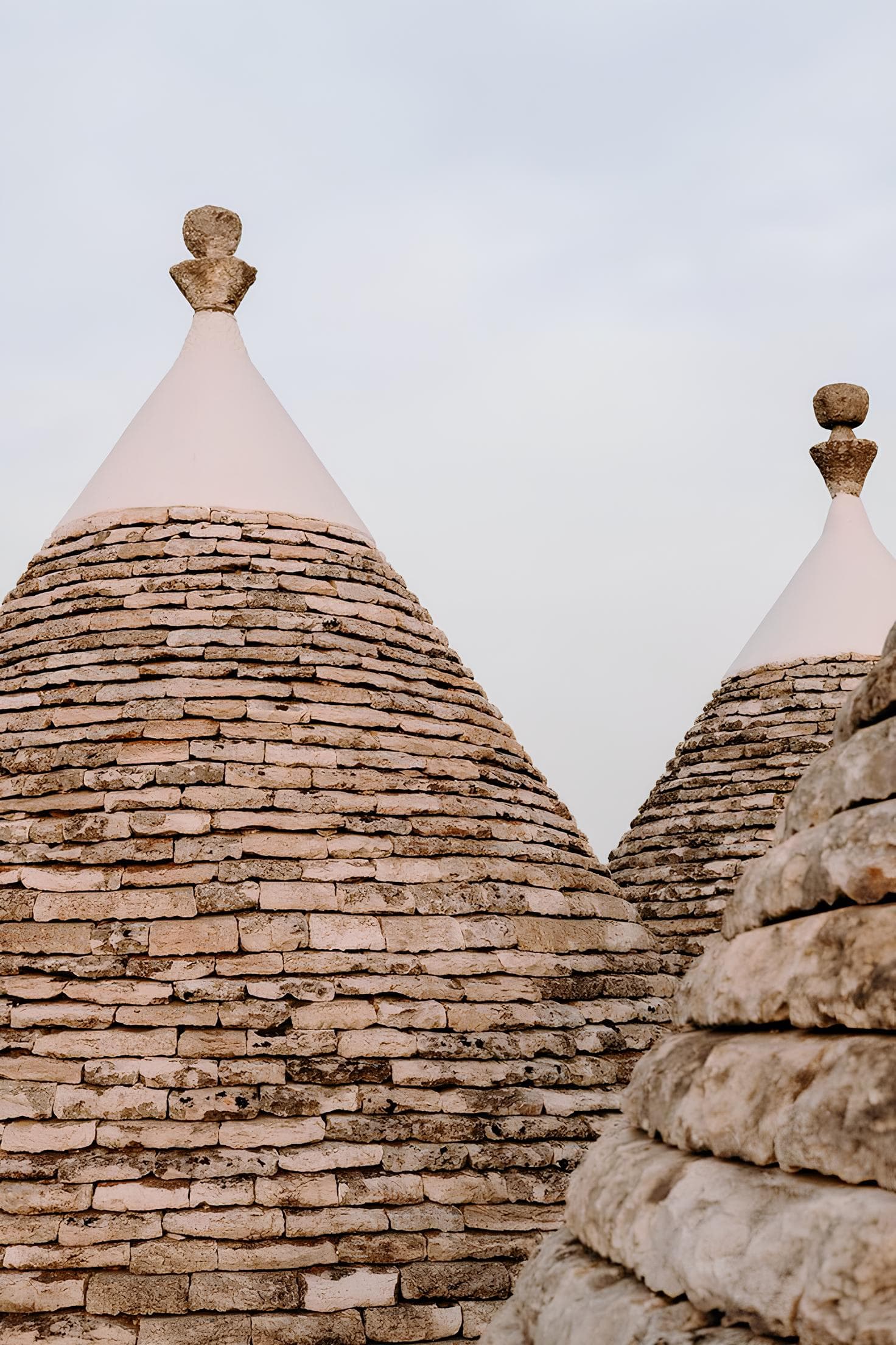 Tetti a cono in pietra a secco dei trulli con pinnacolo, architettura del 1800 nella Valle d'Itria
